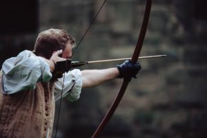 Archer with an arrow drawn ready to shoot in his bow.